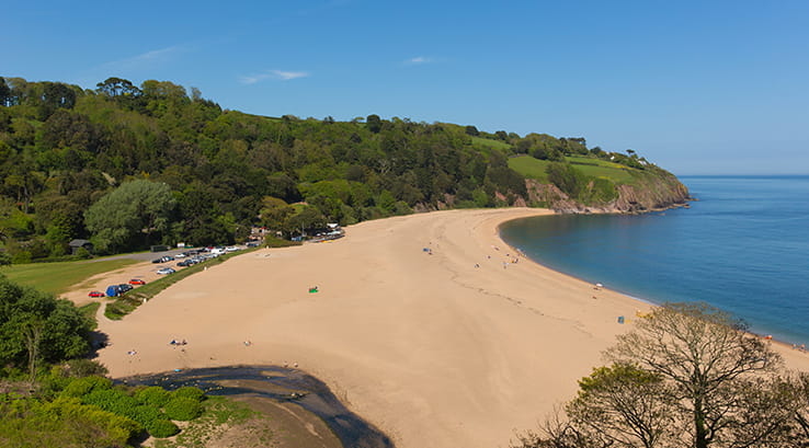Clifftop view of Blackpool sands beach on sunny day