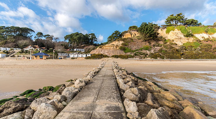 rocky pathway leading through the sand at low tide