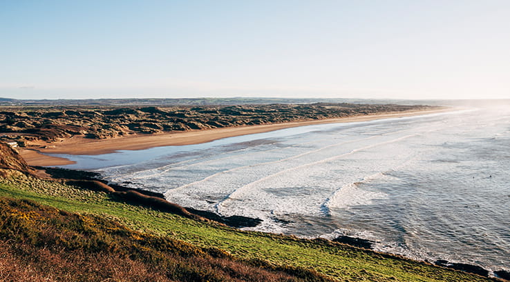 View from clifftop of Saunton sands beach on sunny day