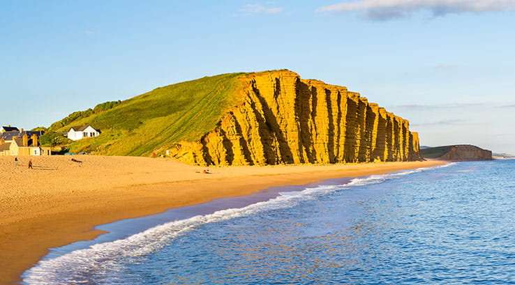 large golden cliff formation along west bay beach