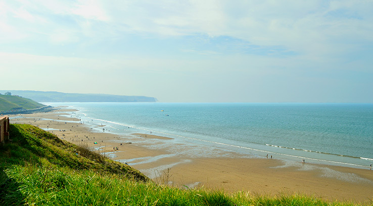Tourists on Whitby beach West Cliff