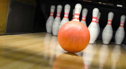 A bowling ball and bowling pins