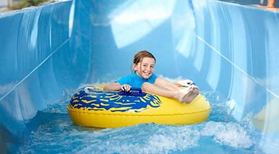 A girl going down a water slide at LC Waterpark