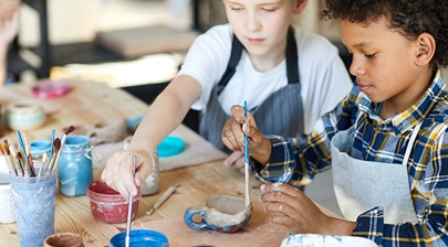 children painting ceramics