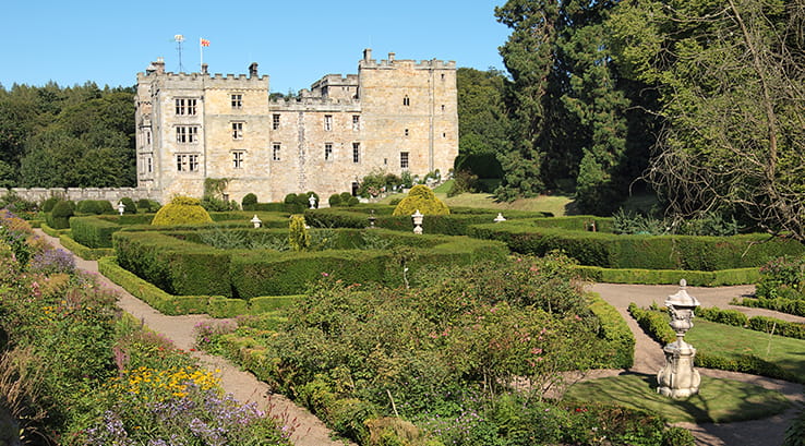A view of Chillingham Castle from across the gardens