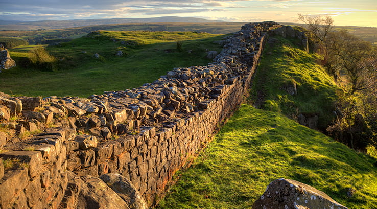 A view looking down towards Hadrian's Wall at sunset