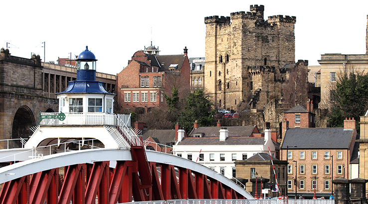 A view of Newcastle Castle with the Swing Bridge in the foreground