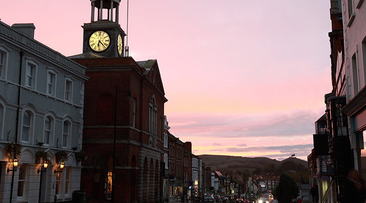 a bridport town street and clock at sunset