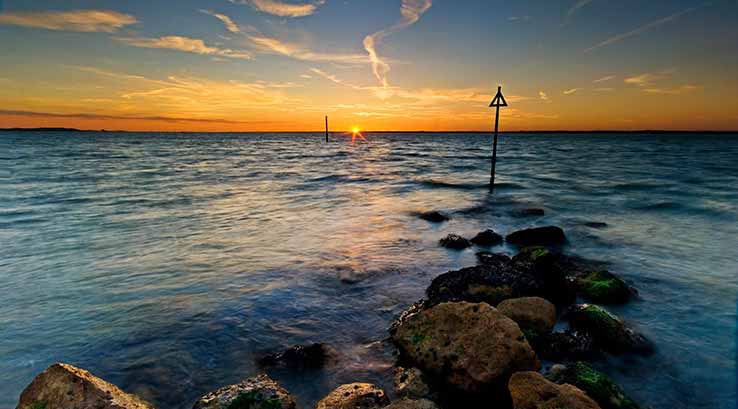 Rocks leading to the sea during sunset