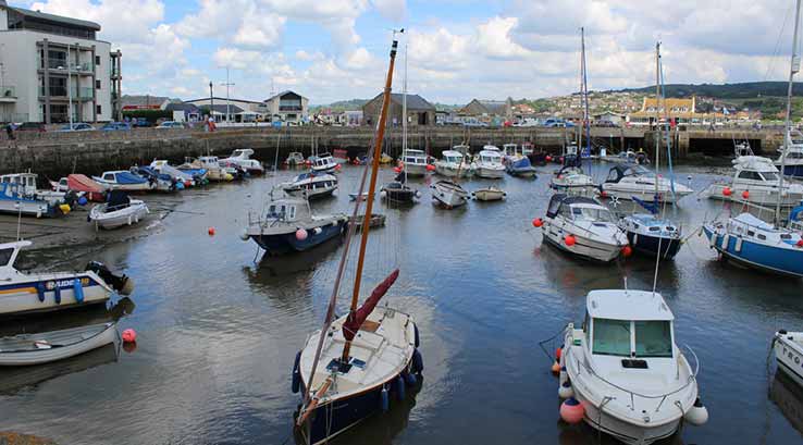 boats moored in the harbour at west bay