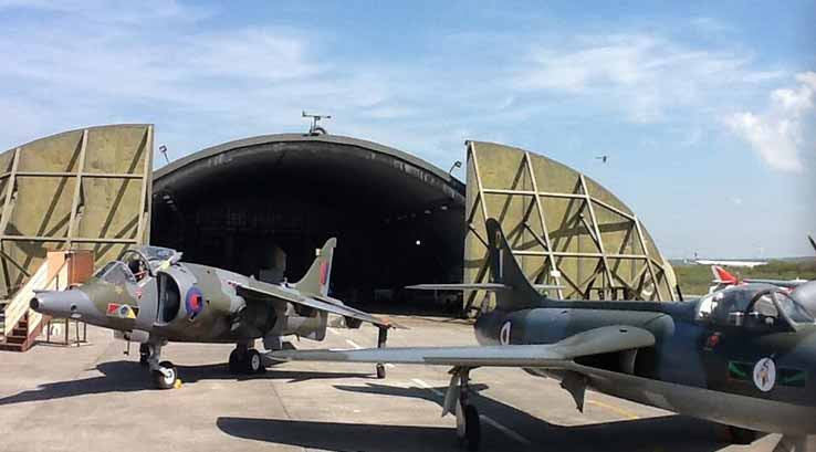 old military aircraft outside a hangar