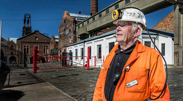A man dressed in mining gear at the National Mining Museum