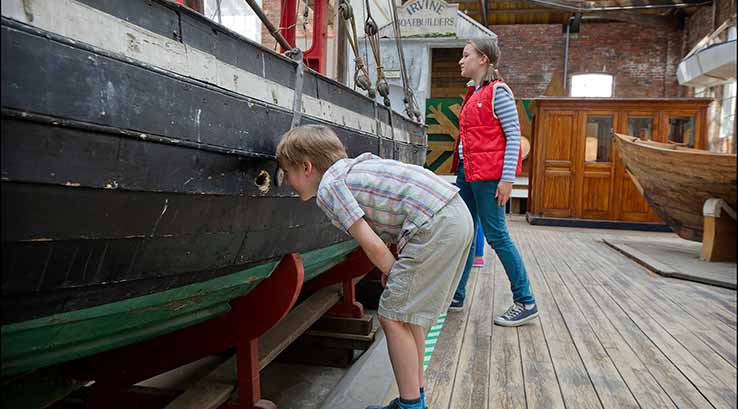 Inspecting an old boat at the Scottish Maritime Museum
