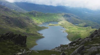 View of the mountains across a lake at Snowdonia National Park