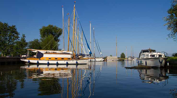 sail boats moored on a river