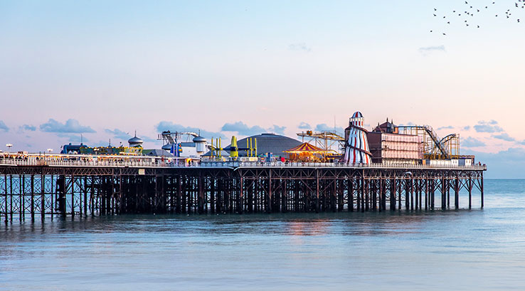 A distant shot across the water of the amusements at Brighton Pier