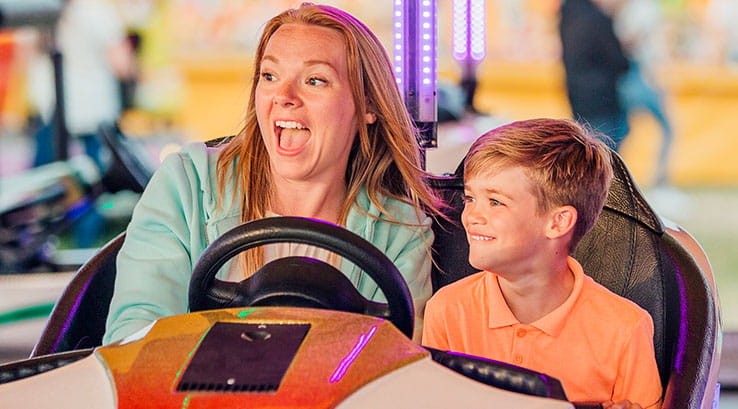 A mother and son riding a dodgem