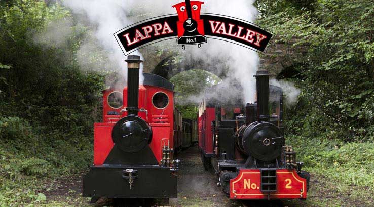 two steam trains with steam coming form the chimneys at lappa valley steam railway