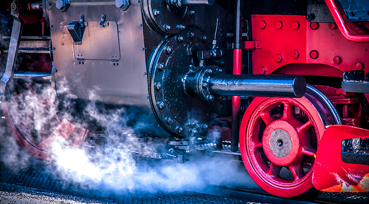 steam train wheel and smoke