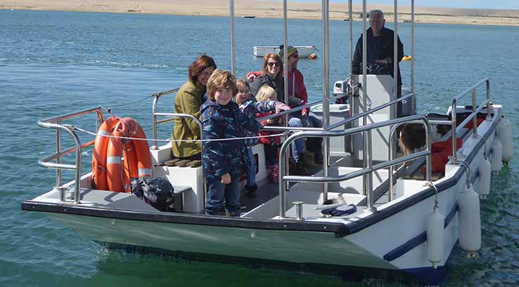 family setting off on a boat to look at wildlife