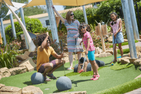 Family playing mini golf at Parkdean Resorts