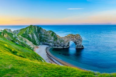 durdle door with its iconic rockface in the sunset