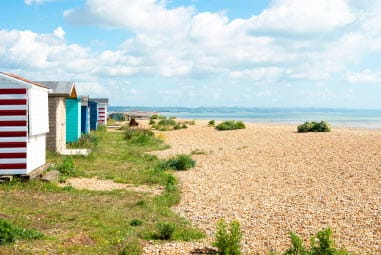 beach huts on the sandy planes of Romney Sands Beach