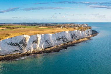 the White Cliffs of Dover from a distance in the sunshine