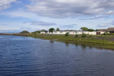 a holiday park with caravans overlooking the sea