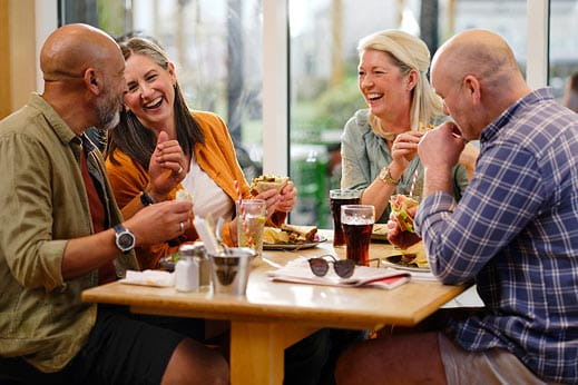 people enjoying food around a table