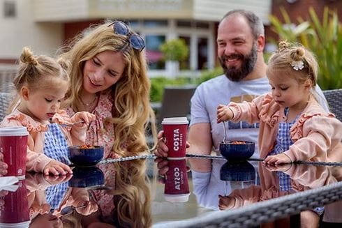 a family enjoying a drink around a table