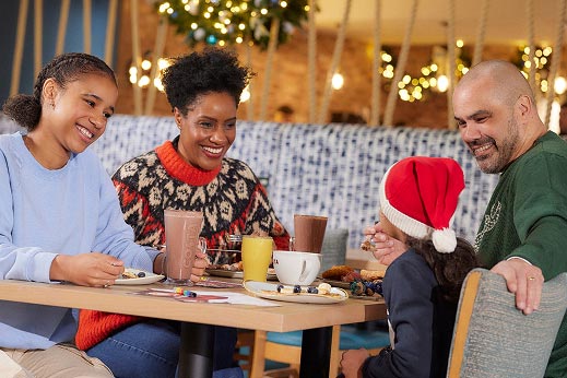 a family enjoying a drink around a table