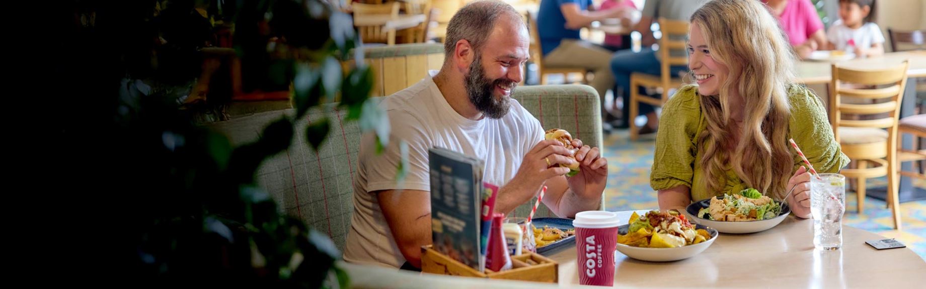 a couple eating food in a restaurant