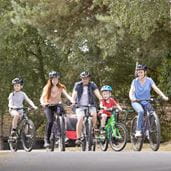Family riding bicycles through Parkdean Resorts