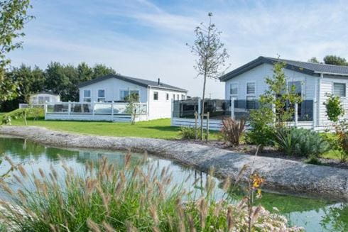Caravans overlooking the lake at Parkdean Resorts