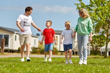 Family walking hand in hand smiling