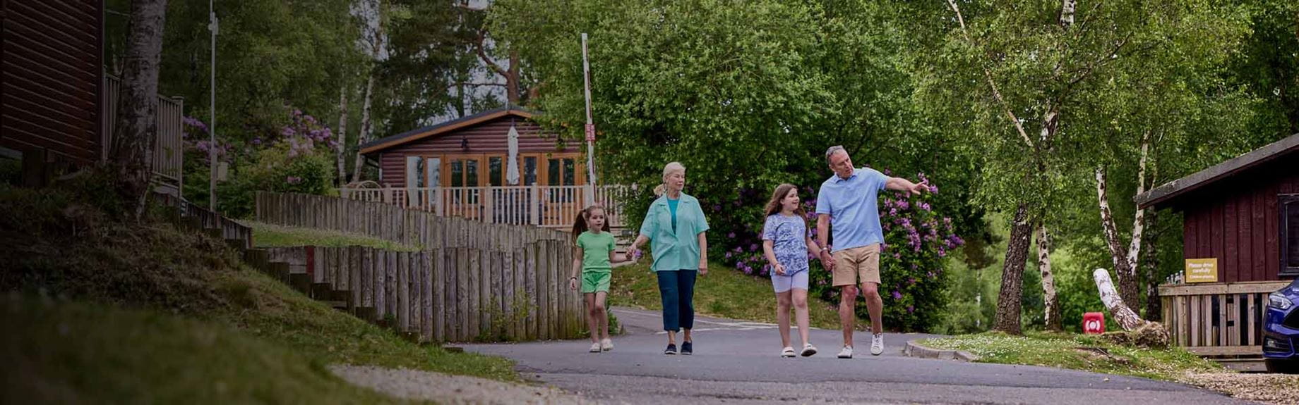 A family walking through Warmwell holiday park