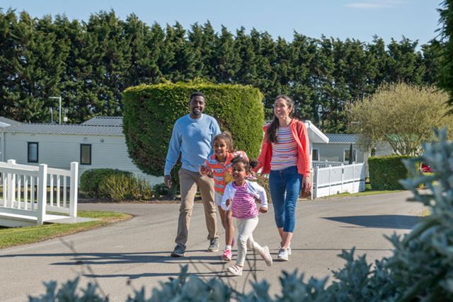 A family walking through a holiday park