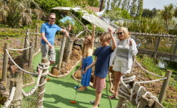 Family taking part in adventure golf