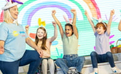 Children cheering for female presenter