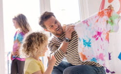 Kid and father doing tie dye
