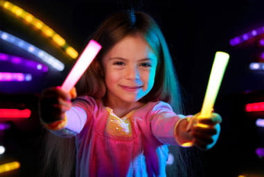 Little girl holding glow sticks