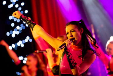 Woman singing and dancing on stage