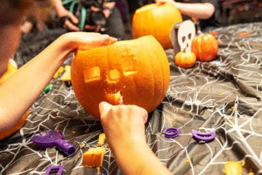 Child carving a pumpkin