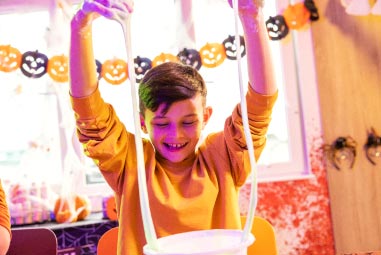 Child playing with Halloween slime
