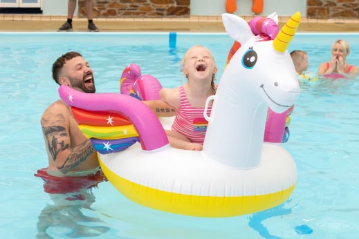 Family in pool with inflatable