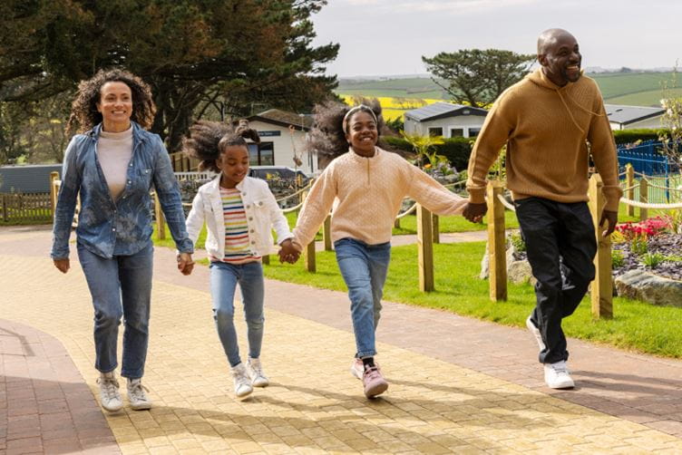 Family walking hand in hand through parkdean resorts 