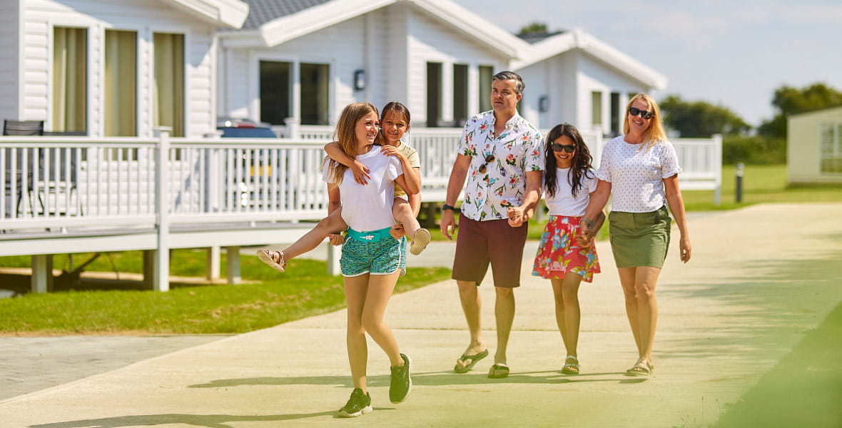 family walking down a path in a caravan site