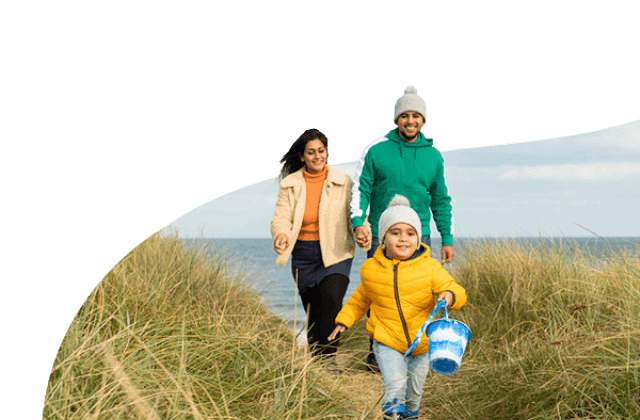 Toddler and parents walking near beach