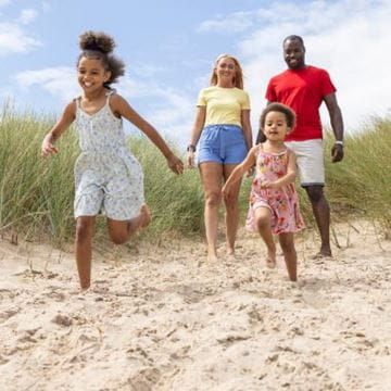 Family running on beach